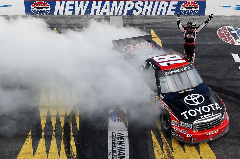 Kyle Busch salutes the fans with donuts and a wave over the granite strip start/finish line after Busch claimed his 21st career NASCAR Camping World Truck Series win on Saturday at New Hampshire Motor Speedway in Loudon, N.H. Credit: Getty Images for NASCAR
